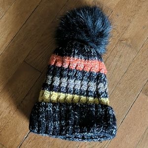 Black striped pom pom hat with soft fur lining